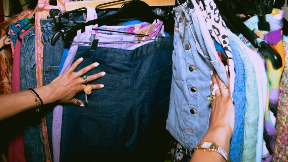 image of someone looking through a clothing rack