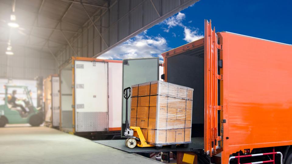 logistics site with articulated vehicle & trailer on loading bay