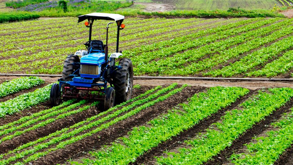 a tractor working on an agricultural farm