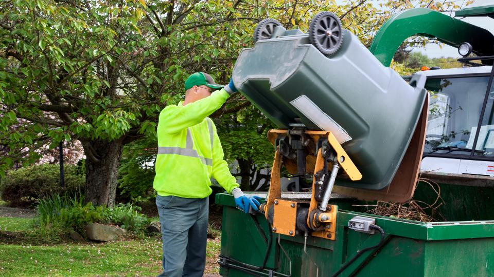 bin collector putting business waste in a lorry