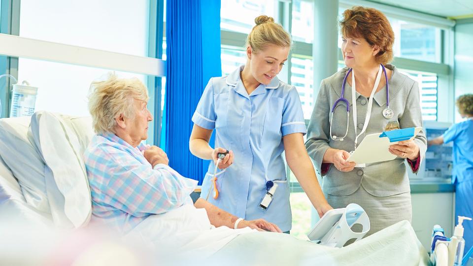nurse helping an elderly lady in a care home