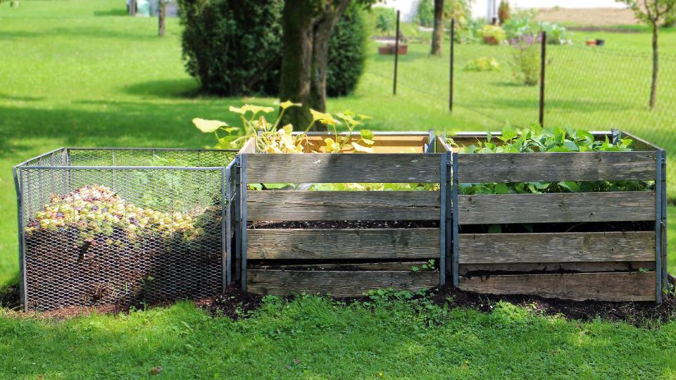 three compost bins outside