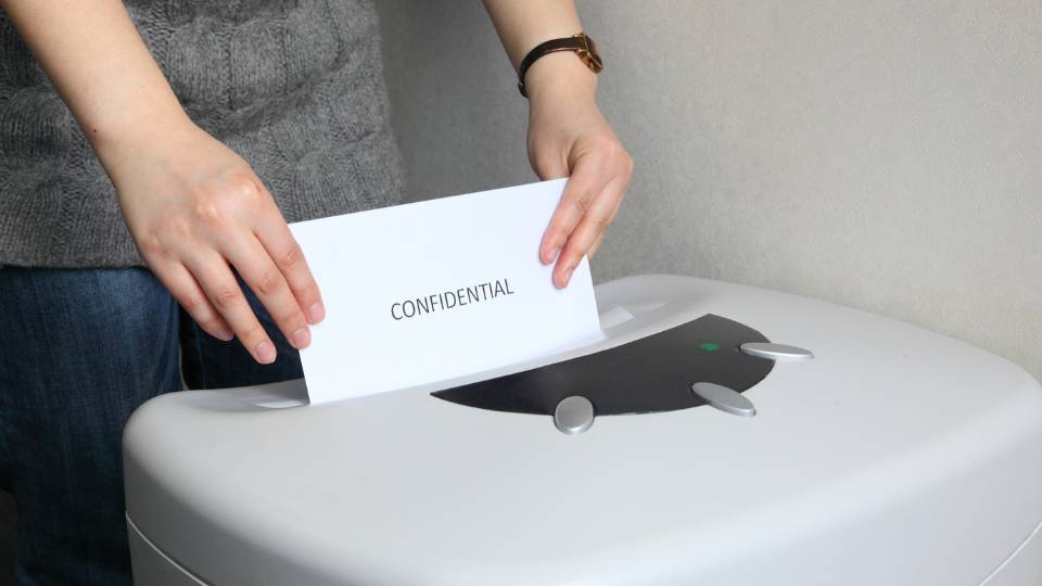 confidential waste going into a confidential waste bin