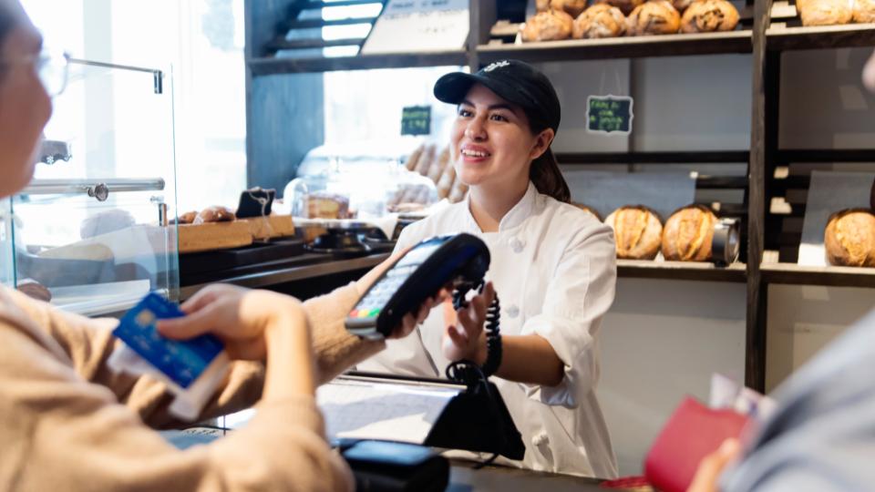 someone purchasing bakery goods at a shop