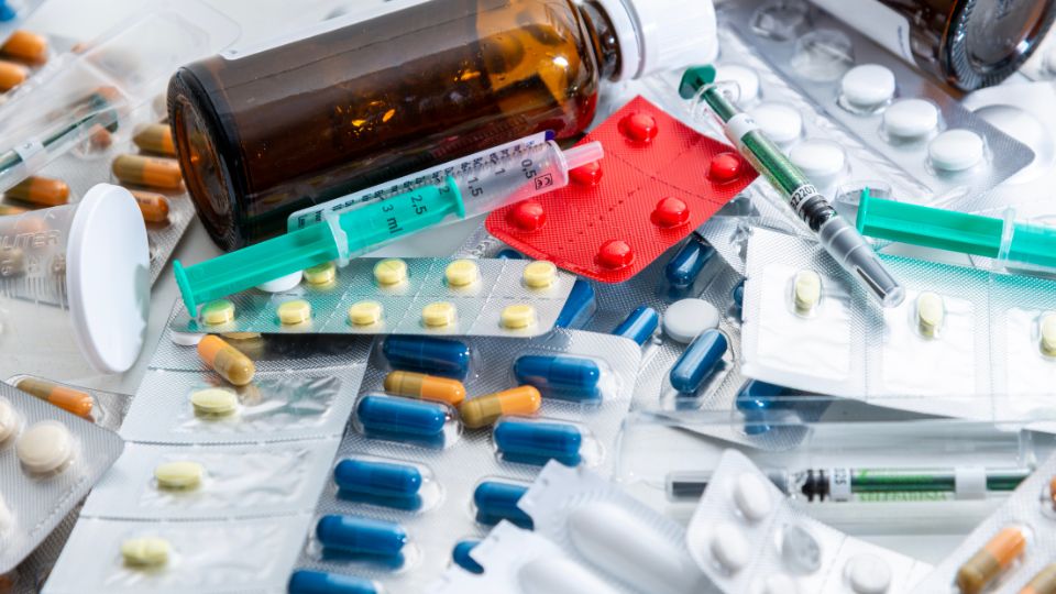 photograph of medical waste from a hospital, unused prescriptions, syringes and bottles