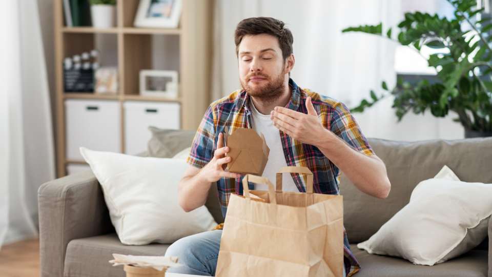 man opening takeaway packaging