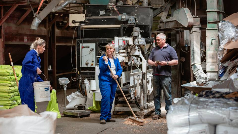 some farmers in a farm waste store
