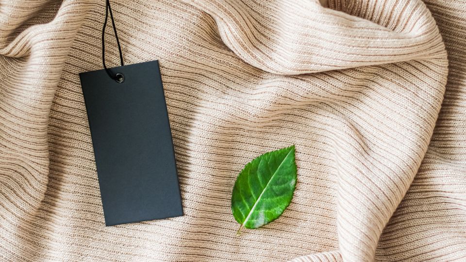 sustainable fashion knit with a leaf and tag on it
