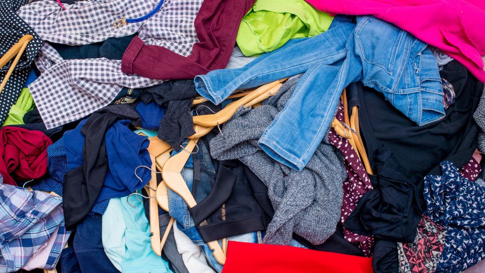 lots of clothes in a pile after being discarded