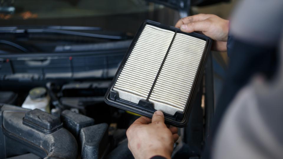 Car air filter going into an engine