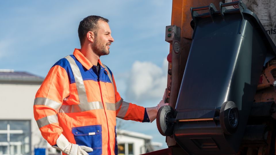a bin man collecting general commercial waste from local businesses