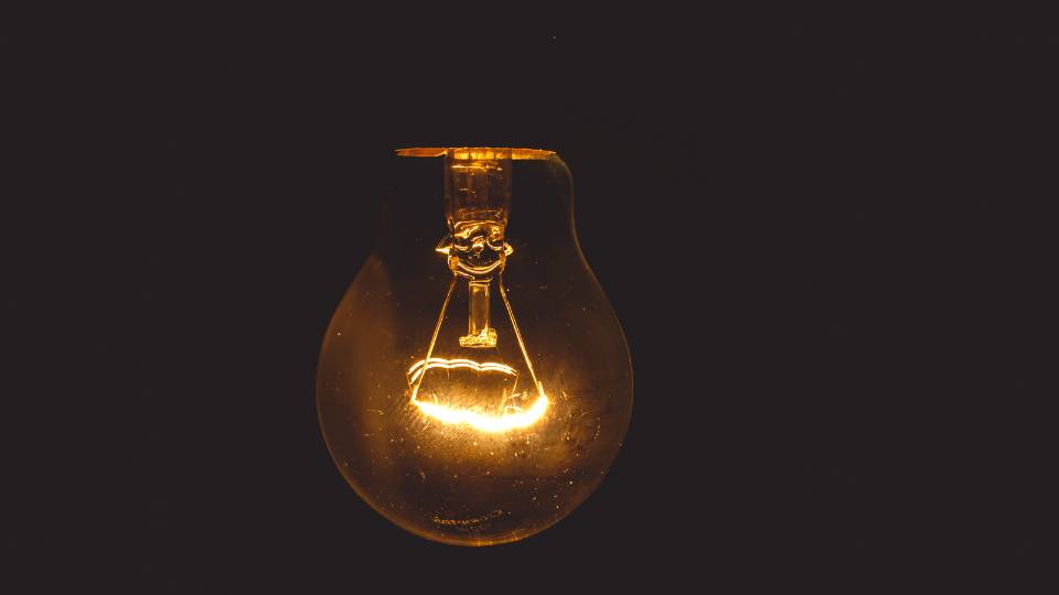 lightbulb shining a bright orange light