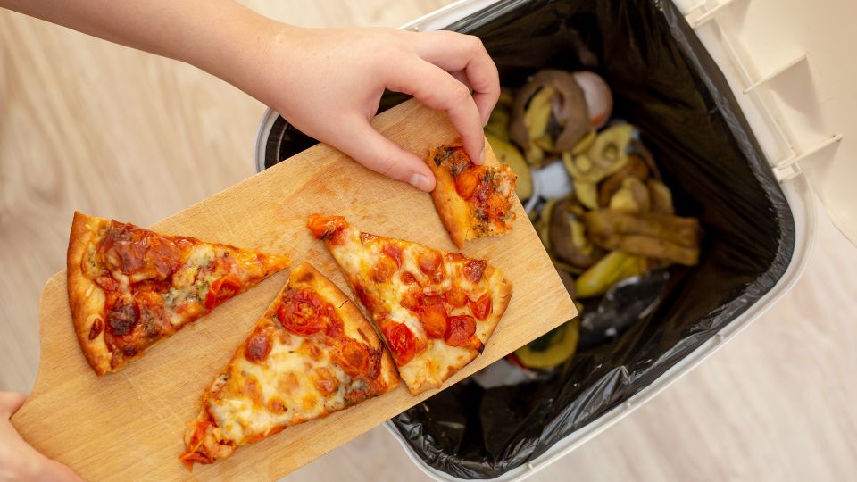 Food waste being emptied into a bin