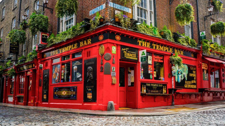 A photograph of a bar in a pub. There are several different lagers, beers and ciders on draught including Heineken, Carlsberg, Guinness, and Budweiser.