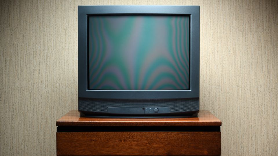 A photo of an old TV on a TV table