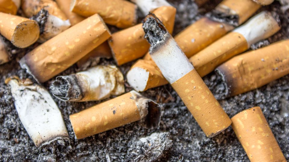 Cigarette butts scattered together.