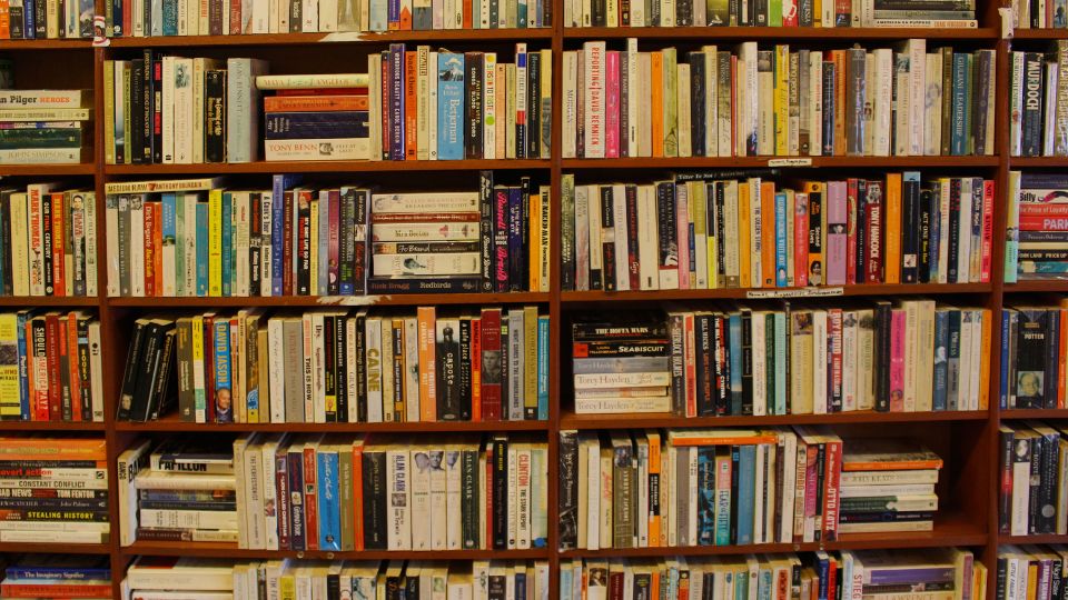Book shelf filled with old books.