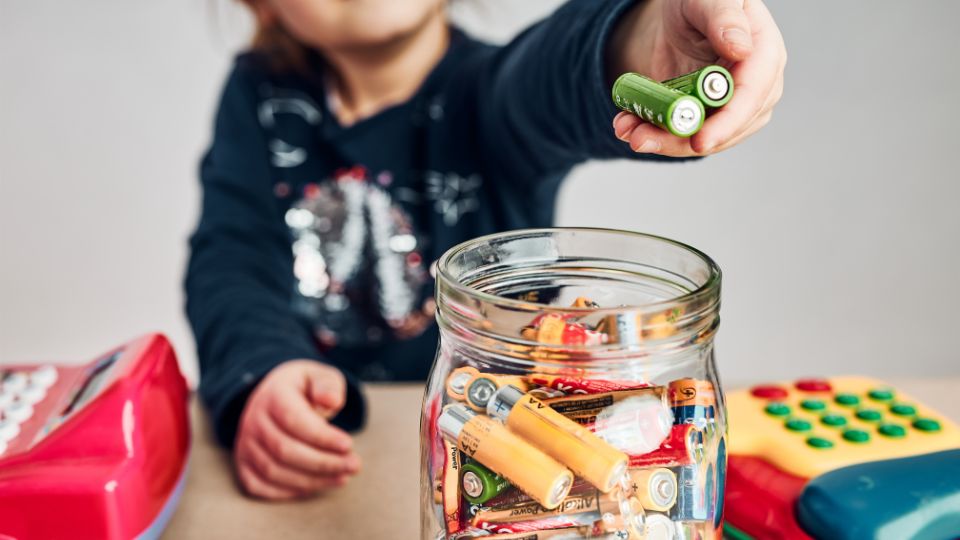 Child disposing batteries.