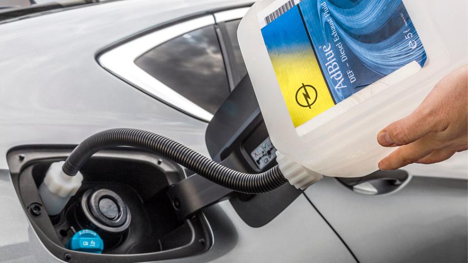 Ad blue being poured into a car