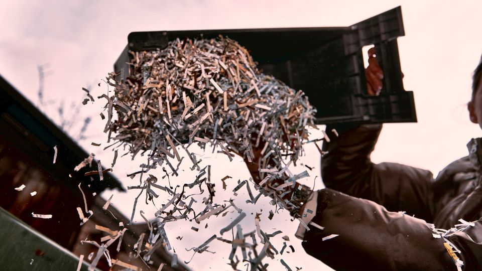 Confidential waste shreddings being thrown away