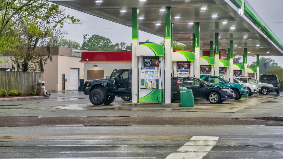 Outside a service station where cars are filling up with petrol