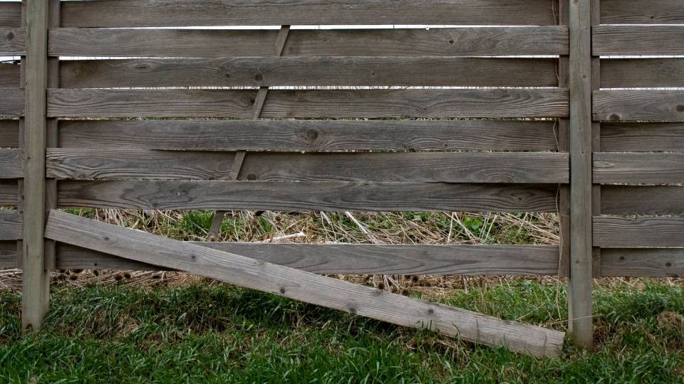 broken wooden fence that needs to be thrown away and disposed of
